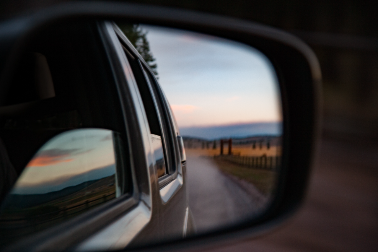 country road trip view from side view mirror