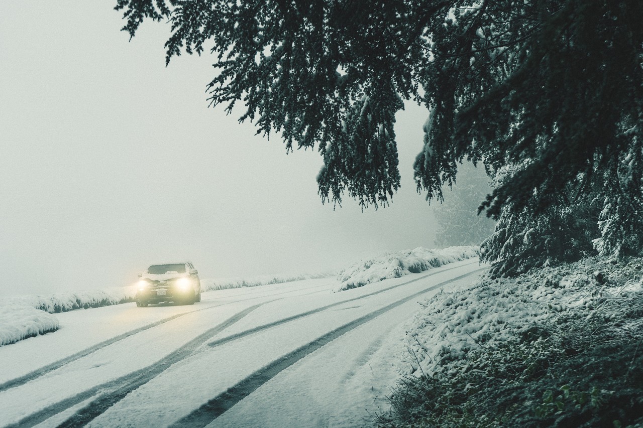 Car driving on the road in the snow