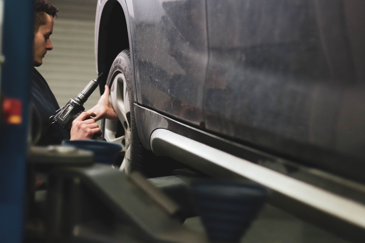 Mechanic checking a cars tyre